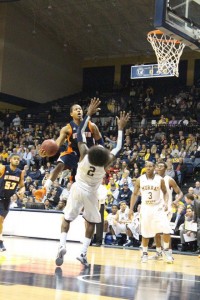 Khristian Taylor goes for a layup. Racer Ed Daniel takes the charge and the ball goes the other way. (Tonya Evans)