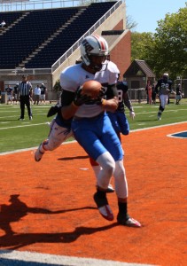 Malik Generett makes a touchdown in left corner of the endzone as his defensive teammates look on. (Malorie Paine)