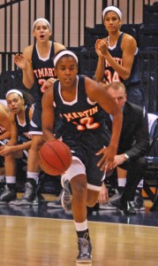 Jasmine Newsome takes the ball down the court as her teammates cheer on the rest of the team. (Alex Jacobi)