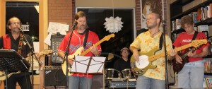 The House Band performs at The Looking Glass in Martin, Tenn. on Sept. 13. Featured in the back is Dr. Chris Brown, professor of philosophy, playing drums. Featured from left to right in the front row is Dr. David Coffey, professor of history and chair of the department of History and Philosophy, playing guitar and singing vocals; Dr. David Carithers, associate professor of English, playing guitar and singing vocals; UTM alumnus Micah Barnes, playing bass; and Dr. Jim Fieser, professor of philosophy, playing lead guitar and backing vocals. (Sheila Scott)