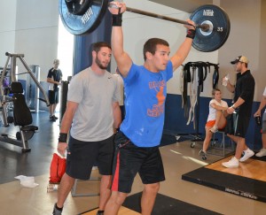 Senior Agriculture Engineering major Michael Gooch spots senior Health and Human Performance major Dexter Ridings during some Olympic style weight lifts. Gooch and Ridings are training for the 2014 Crossfit Games, which requires training for constantly varied, functional movements that are performed at high intensities. (Mary Jean Hall)