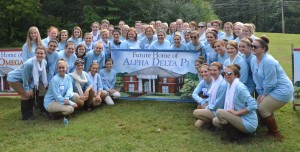 Current members of the Alpha Delta Pi sorority gather around their sign during the groundbreaking ceremony. (Mary Jean Hall)