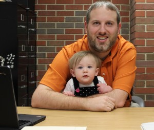 Raven Kunkel is checking out the view from her daddy's desk trying to decide early if she might like being a teacher like her dad, Curtis Kunkel, associate professor of Mathematics and Statistics. (Sheila Scott)