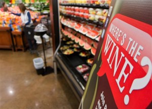 In this Nov. 30, 2012 file photo, a sign in a Kroger supermarket in Nashville, Tenn., urges shoppers to sign up for a group urging lawmakers to change state law that limits wine sales to liquor stores. State lawmakers on Tuesday, Jan, 21, 2014 reconvened the 108th Tennessee General Assembly in a legislative session that is expected to feature debates over creating a school voucher program and whether to allow supermarkets to sell wine. (AP Photo/Erik Schelzig, file)