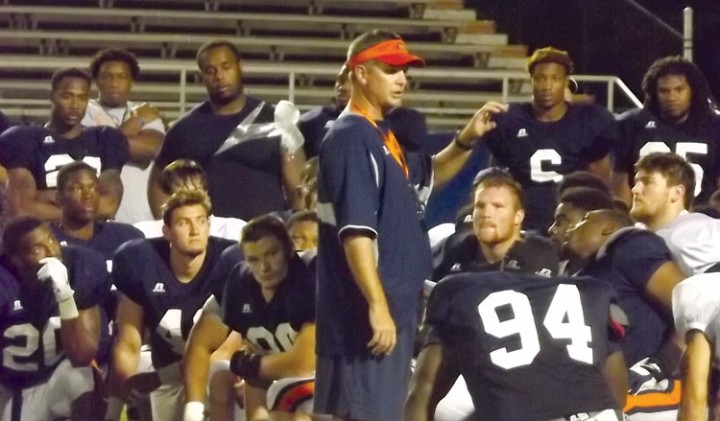 Coach Simpson instructs his team after the scrimmage. (Jared Peckenpaugh)