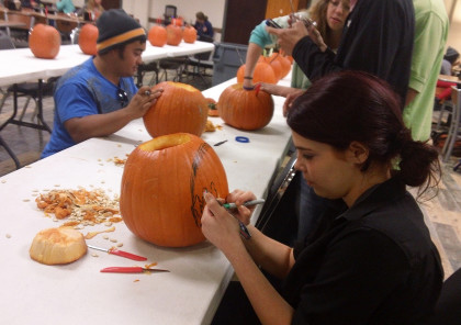 Contestants in the SAC pumpkin-carving contest plan and prepare their pumpkins for the competition.