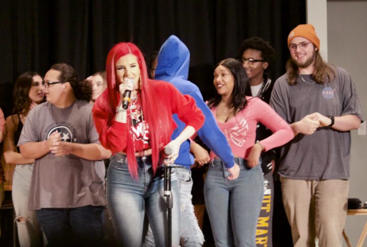 Justina Valentine on stage with participants of the Wild 'N Out games. 
