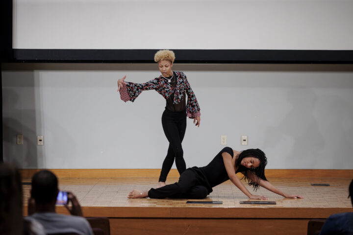 Two dancers performing their piece on stage.
