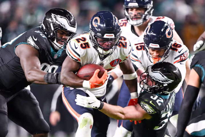 Chicago Bears running back Kyle Monangai (25) runs through Philadelphia Eagles defenders at Lincoln Financial Field on Nov. 28, 2025. (The Philadelphia Inquirer/Jose F. Moreno)